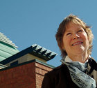 Nancy E. Wood headshot in front of a building