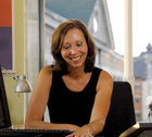 Loretta Roby sitting at a desk and smiling