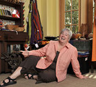 Nancy T. Lynch posing on the floor of an office