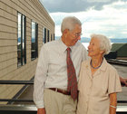 Elizabeth and Lester Wallman looking at eachother in front of Lake Champlain
